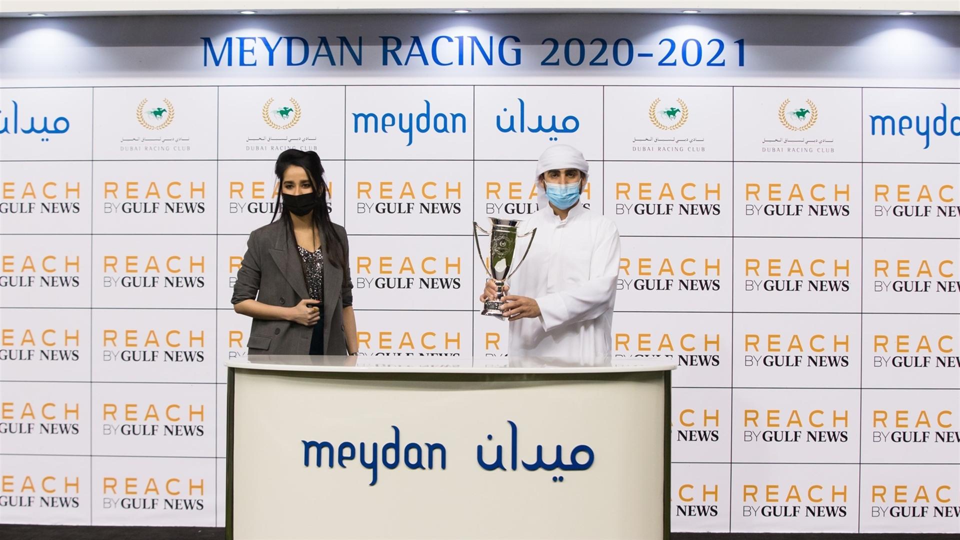 Muataz Amira accepts the trophy for the REACH by Gulf News, from Ms. Sameera Mohammed, Account Group Manager on January 30, 2021. (Credit: Erika Rasmussen // DRC))
