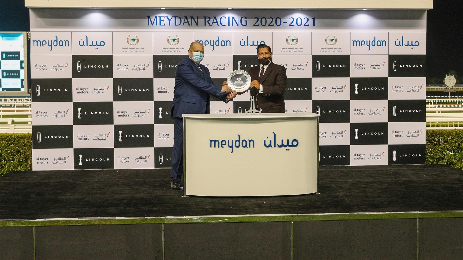 Satish Seemar accepts the trophy for the Lincoln Corsair, from Mr. Helal Omar, Senior Vice President Ford & Lincoln, Al Tayer Motors, on January 16, 2021. (Credit: Dubai Racing Club)