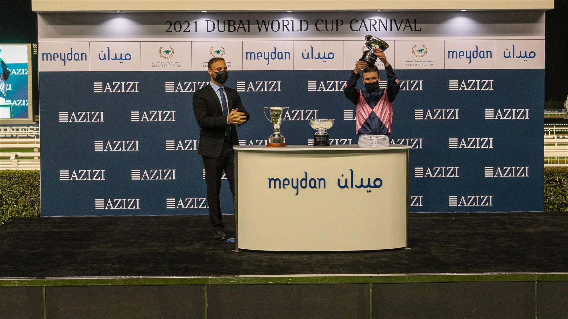 Adrie de Vries accept the trophy for the Singspiel Stakes Sponsored By Riviera By Azizi, from Mr. Farhad Azizi, CEO, Azizi Developments, on January 21, 2021. (Credit: DRC)
