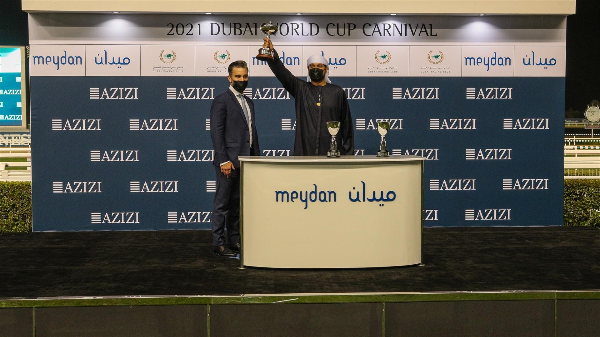 Abdulla Muammer accepts the Trophy for the Dubawi Stakes Sponsored By Park Avenue By Azizi, from Mr. Yousef Mehrabi, Chief Internal Auditor, Azizi Developments, on January 21, 2021. (Credit: DRC)