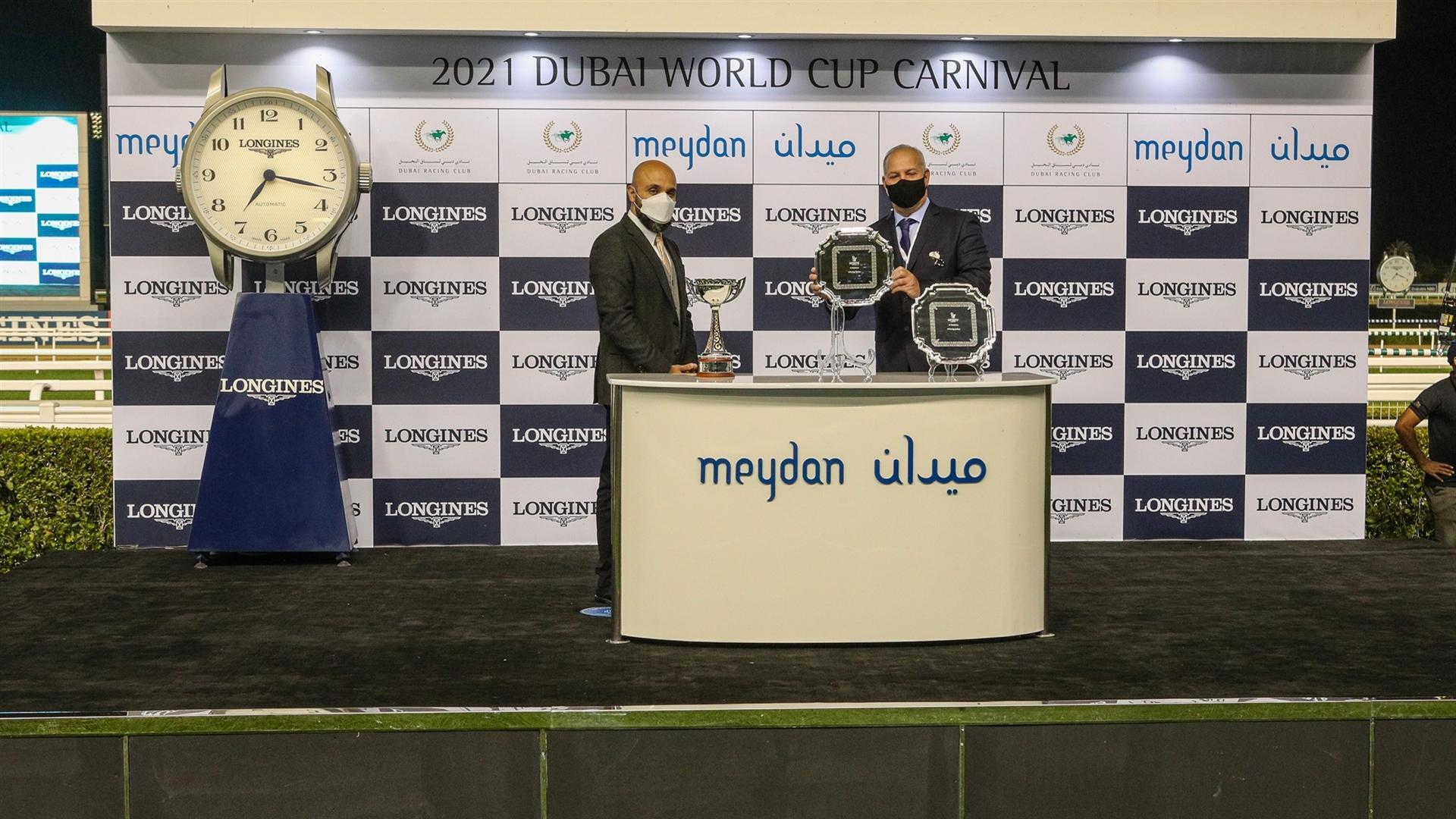 Winning trainer Antonio Cintra Pereira accepts the trophy for the Al Bastakiya Trial Presented By Longines, from Mr. Patrick Aoun, Regional Brand Manager Longines, on January 28, 2021. (Credit:DRC)