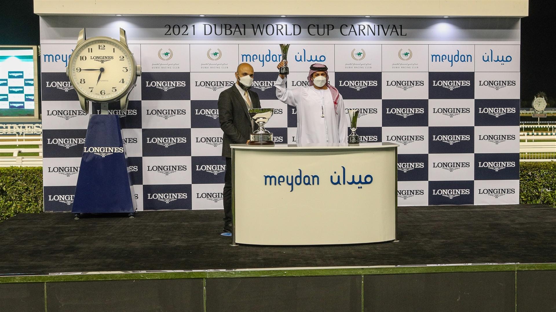 Tahnoon Alalawi accepts the trophy for the Al Maktoum Challenge R2 Presented By Longines - from Mr. Patrick Aoun, Regional Brand Manager Longines, on January 28, 2021. (Credit:DRC)