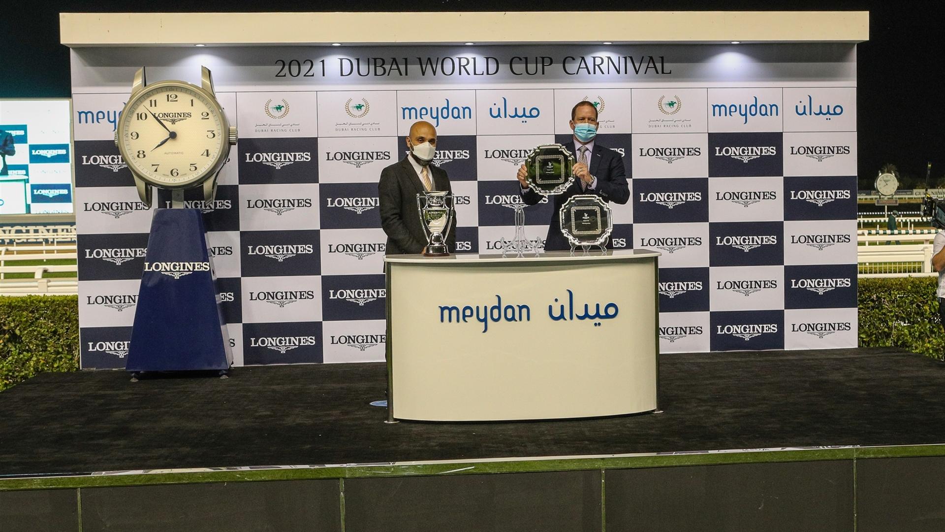 Rod Daniel accepts the trophy for the Zabeel Turf Presented By Longines from Mr. Patrick Aoun, Regional Brand Manager Longines, on January 28, 2021. (Credit: Dubai Racing Club)