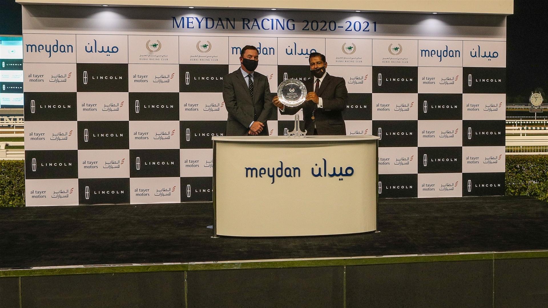 Satish Seemar accepts the trophy for Lincoln Navigator, from Mr. Paul Moore, Managing Director, Lincoln, Direct Markets, on January 16, 2021. (Credit: Dubai Racing Club)