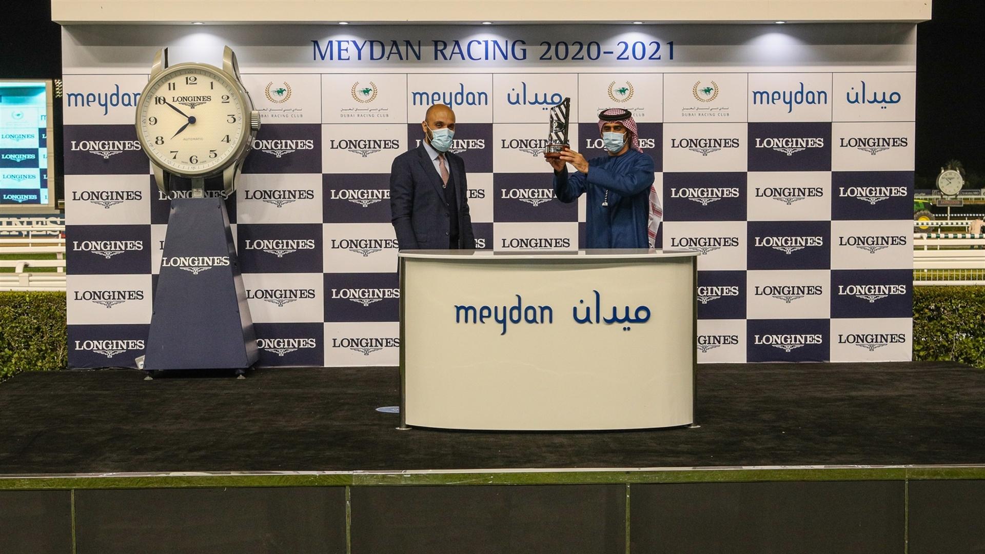 Salem Al Sabouse accepts the trophy for the Longines Spirit Collection Trophy, from Mr. Patrick Aoun Regional Brand Manager, Longines, on January 07, 2021.(Credit: Dubai Racing Club )