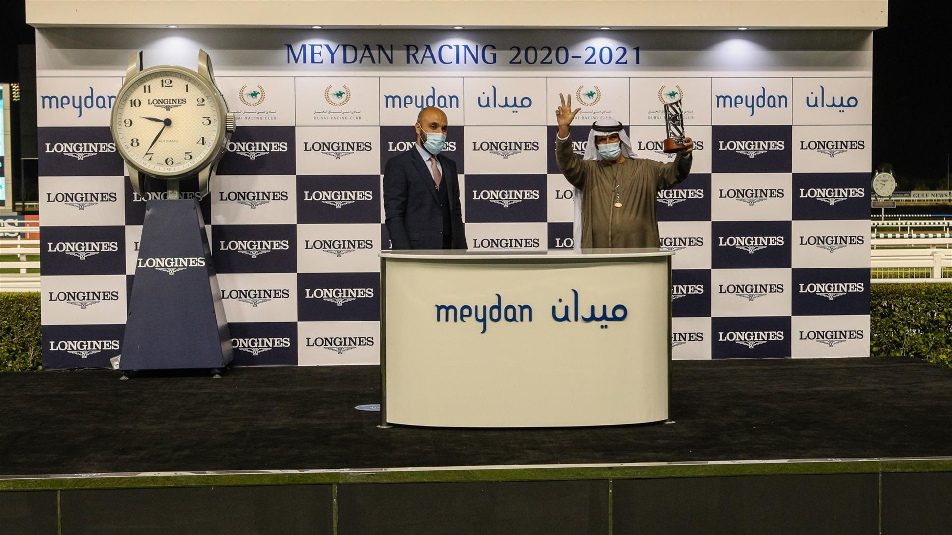 Ali Rashid Al Rayhi accepts the trophy for the Longines Spirit Collection Challenge, from from Mr. Patrick Aoun, Regional Brand Manager, Longines, on January 07, 2021. (Credit: Dubai Racing Club)