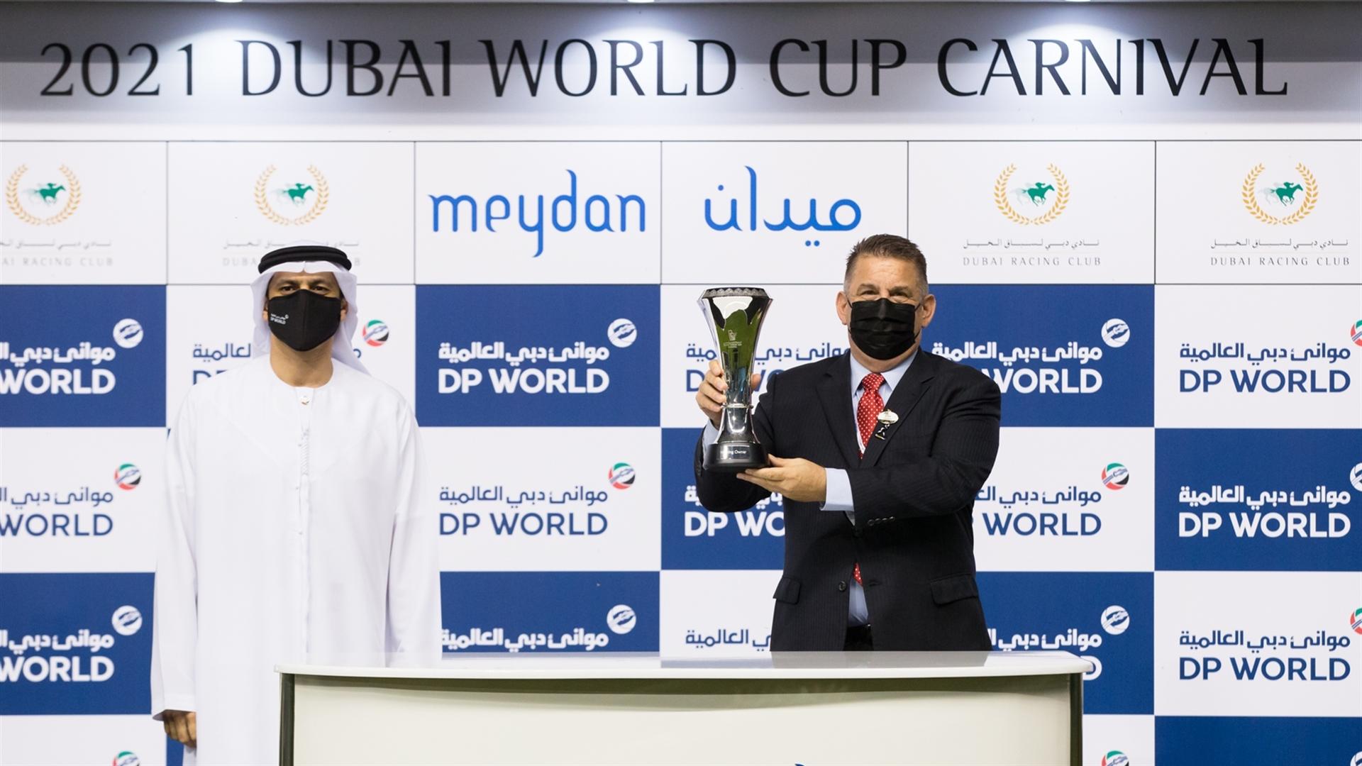 Doug Watson accepts the trophy for the Mina Rashid race from Mr. Shahab Al Jassmi, Director - Ports &Terminals, Commercial on February 4, 2021. (Credit: Erika Rasmussen//Dubai Racing Club)
