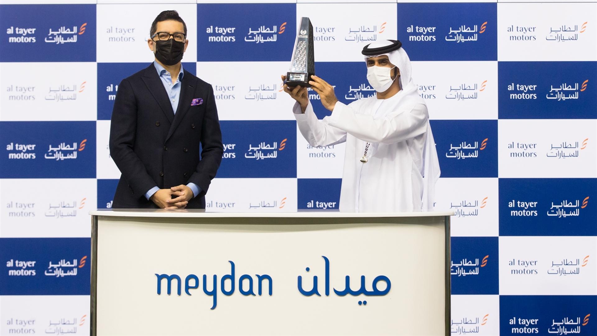 Salem Al Sabouse accepts the trophy for the Al Tayer Motors Handicap Sponsored By Al Tayer Motors from Mr. Owais Tungekar, Asst. Gen. Mngr, Land Rover Sales, Al Tayer Motors (Credit:DRC // ER)