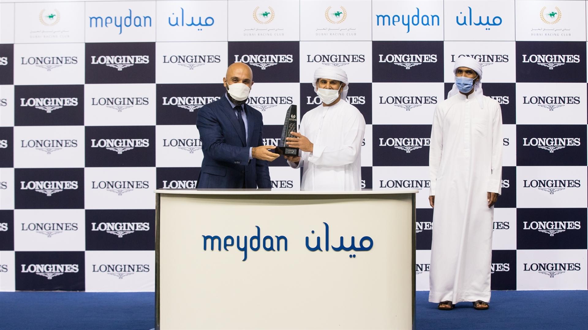Salem bin Ghadayer accepts the trophy for the Longines Stakes Presented By Longines from Mr. Patrick Aoun, Regional Brand Mngr for the ME&SEA, Longines, on April 8, 2021.(Credit:DRC//Erika Rasmussen)