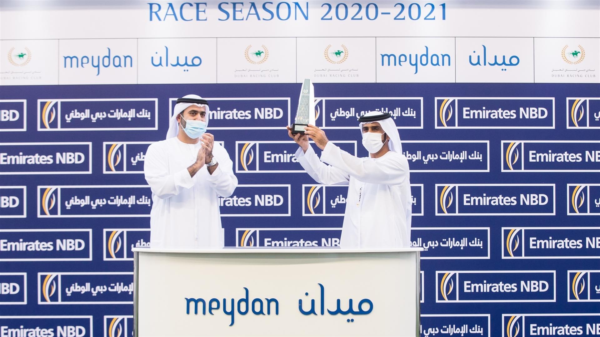Salem Al Sabouse accepts the trophy for the Emirates NBD Handicap Sponsored By Emirates NBD from Mr. Mohammad Al Bastaki, Sen. VP Head of Public Sector, Emirates NBD, on April 8, 2021.(Credit:DRC//ER)