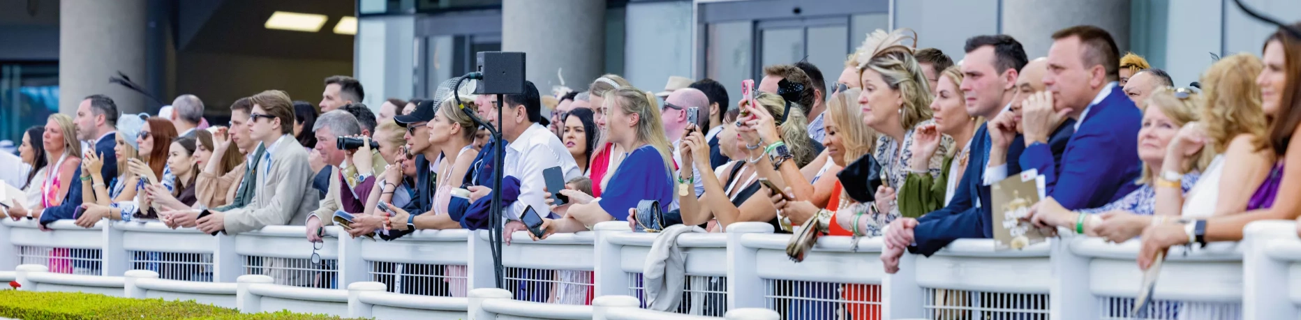 Spectators watching races from rails
