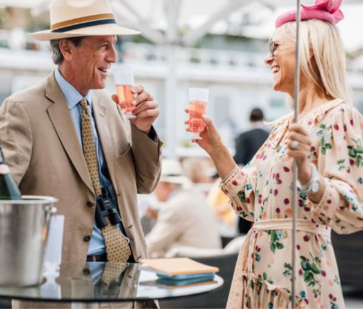 Elegant guests toasting at races