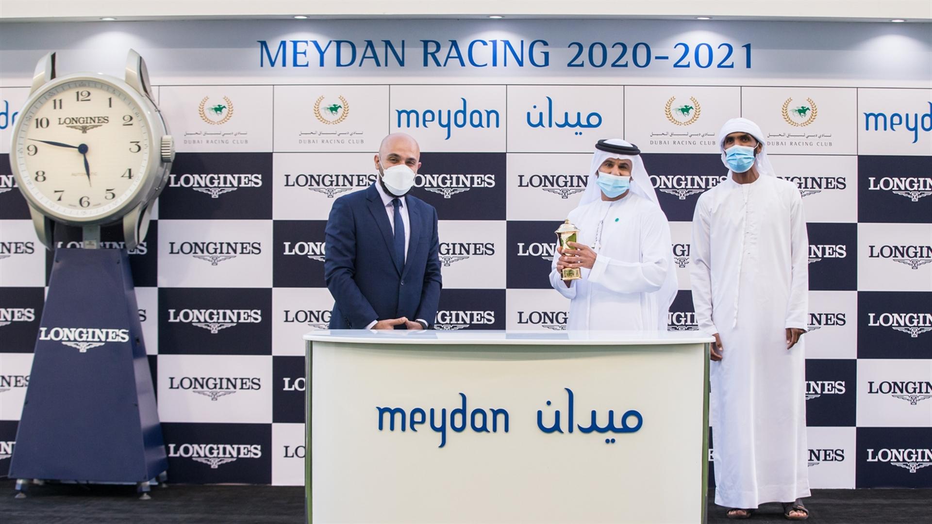 Salem bin Ghadayer accepts the trophy for the Longines Spirit Collection Mile, from Mr. Patrick Aoun, Regional Brand Manager, on February 13, 2021. (Credit: Dubai Racing Club // Erika Rasmussen)