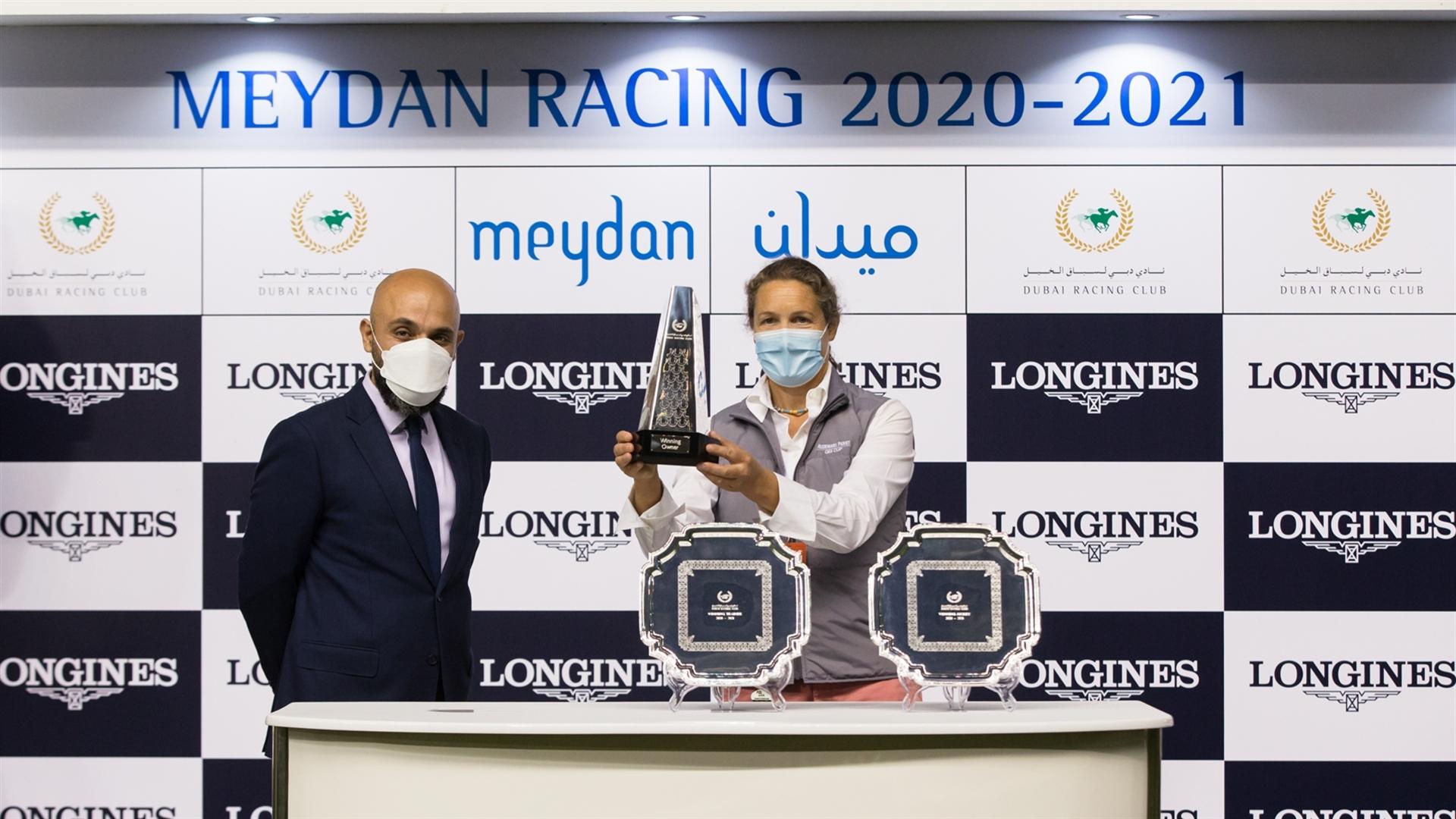 Sophie Chretien accepts the trophy for the Longines Spirit Collection Stakes from Mr. Patrick Aoun, Regional Brand Manager on February 13, 2021. (Credit: Dubai Racing Club // Erika Rasmussen)