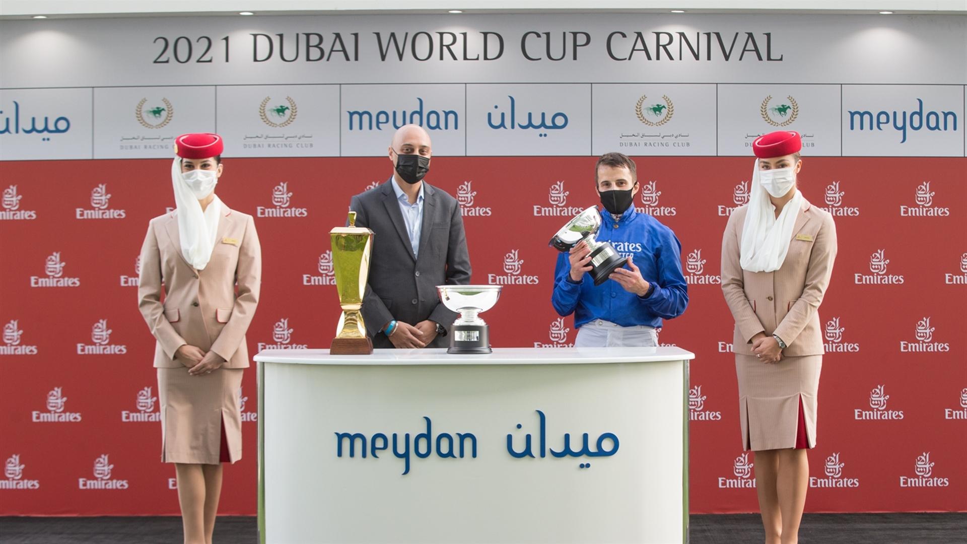 Patrick Dobbs accepts the trophy for the Mahab Al Shimaal Sponsored By Emirates Skywards race from Khalid Al Haddad, VP Skywards Members & Ops. on March 06, 2021. (Credit: Erika Rasmussen//DRC)