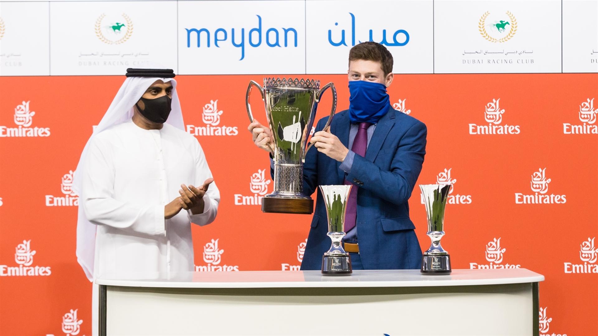 Mathew Ennis accepts the trophy for the Jebel Hatta Sponsored By Emirates Airlines from Khalid Bel Jaflah, Divisional VP Commercial Ops on March 06, 2021. (Credit: Erika Rasmussen//Dubai Racing Club)
