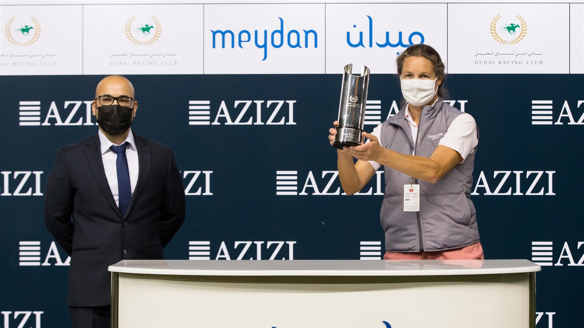 Sophie Chretien accepts the trophy for the Creek Views By Azizi from Fawad Azizi, Deputy CEO, on March 11, 2021. (Credit: Dubai Racing Club // Erika Rasmussen)