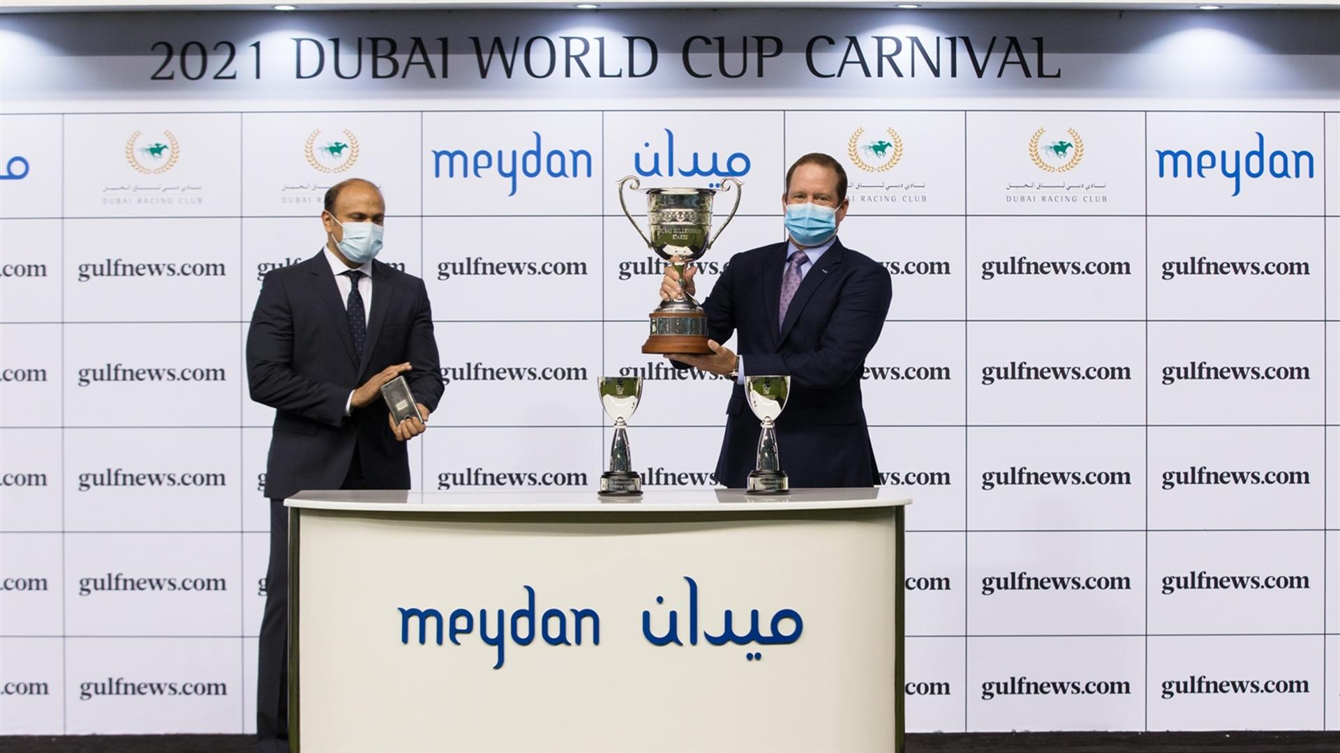 Dr. Rod Daniel accepts the trophy for the Dubai Millennium Stakes Sponsored By gulfnews.com, from Sandeep Suvarna, Head of Sales - Digital on February 25, 2021. (Credit: Erika Rasmussen//DRC)