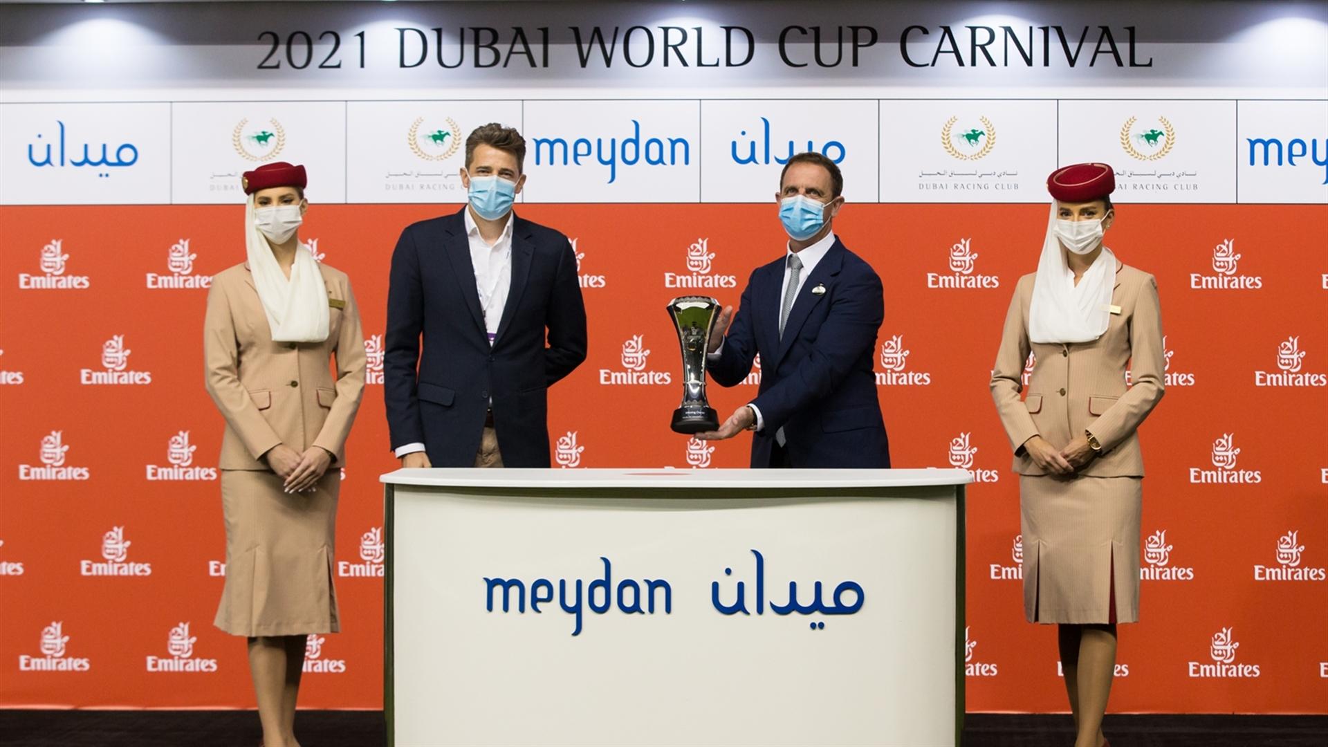 Trainer Charlie Appleby accepts the trophy for the Emirates SkyCargo, Handicap race, from Dennis Lister - VP Cargo Commercial Development, on February 11, 2021. (Credit: Erika Rasmussen//DRC))