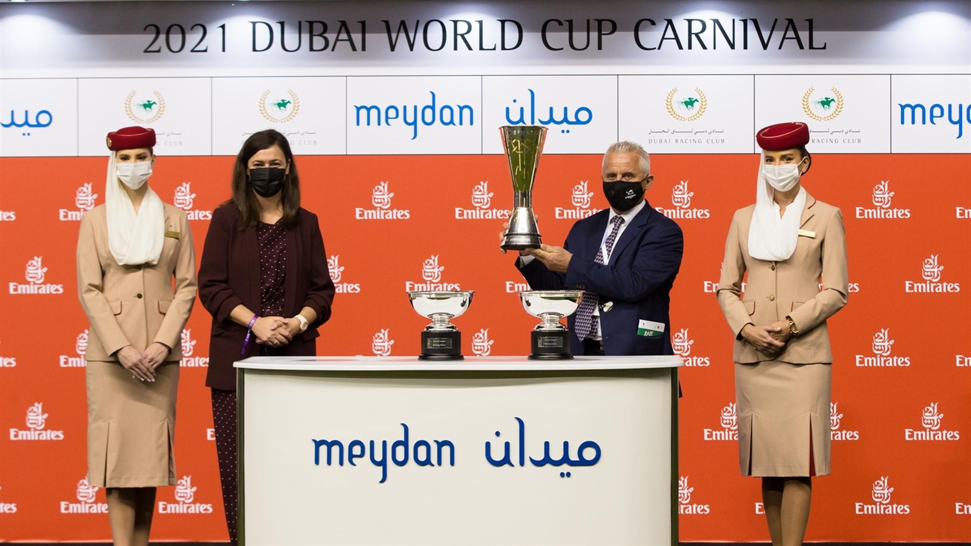 Eric Lemartinel accepts the trophy for Mazrat Al Ruwayah Sponsored By Arabian Adventures from Elisabete Silva, Arabian Adventures Sales Manager on February 11, 2021. (Credit: Erika Rasmussen//DRC)