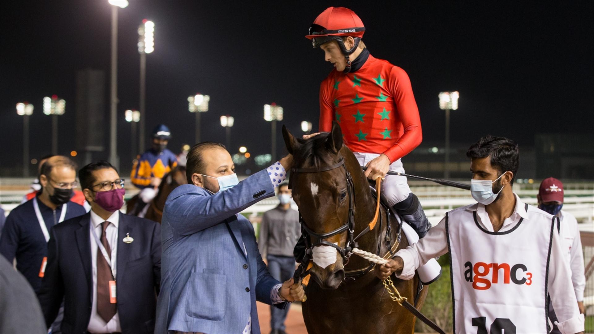Moshaher (USA) (Satish Seemar - Harry Bentley) wins the Agnc3 - 1000m, turf, handicap race at the eighth Racing at Meydan meeting on January 30, 2021. (Credit: Dubai Racing Club // Erika Rasmussen)