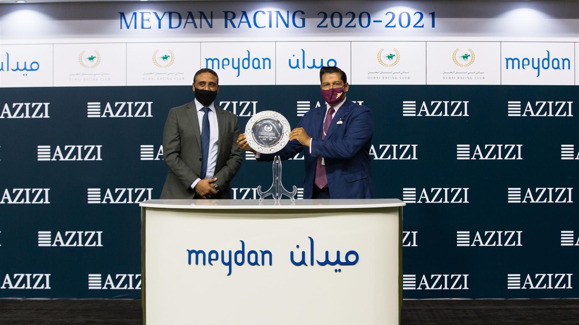 Winning trainer Satish Seemar accepts the trophy for the Al Furjan By Azizi from Mohamed Ragheb, Chief Development Officer, on March 11, 2021. (Credit: Dubai Racing Club // Erika Rasmussen)