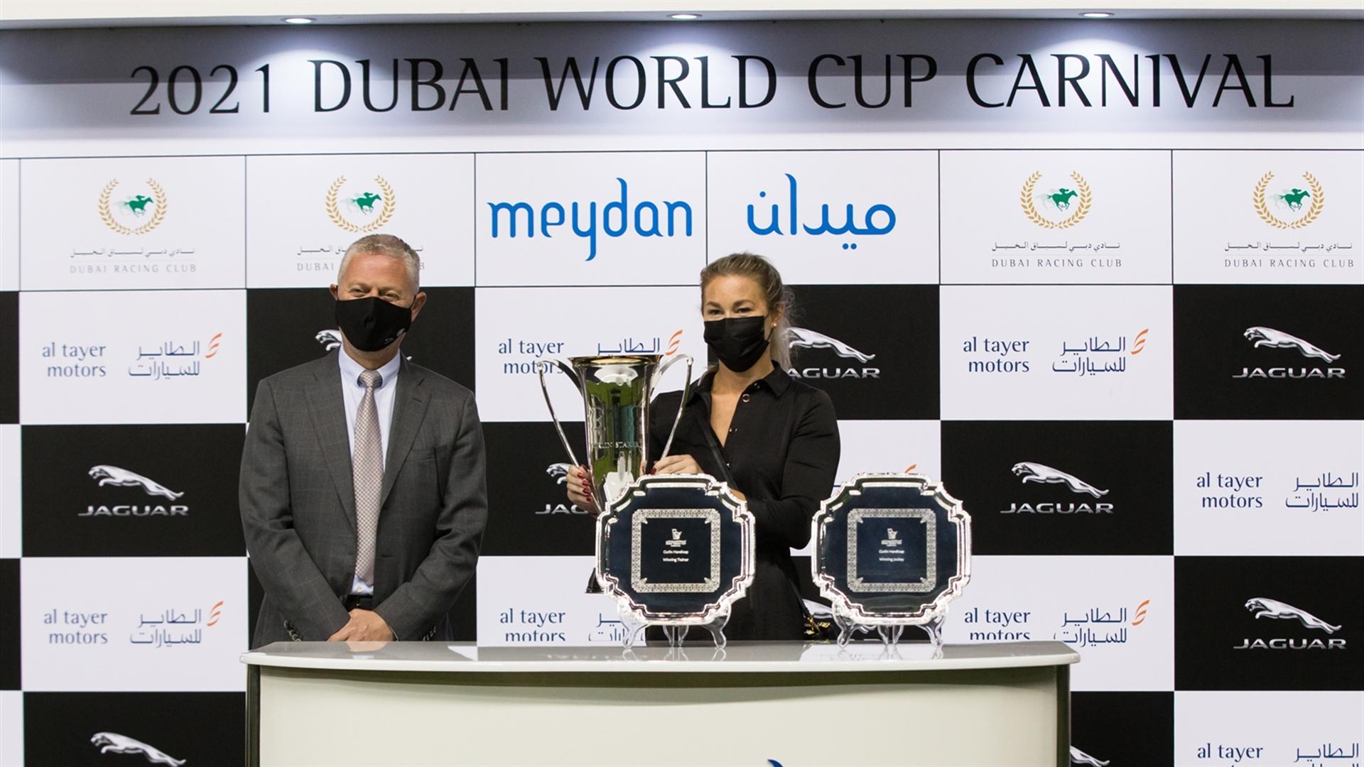 Veronica Aske accepts the trophy for the Curlin Stakes Sponsored By New Jaguar F-Pace race from Boulos Massoud, Senior VP-Aftersales, Al Tayer Motors on Feb 18, 2021. (Credit:Erika Rasmussen//DRC)
