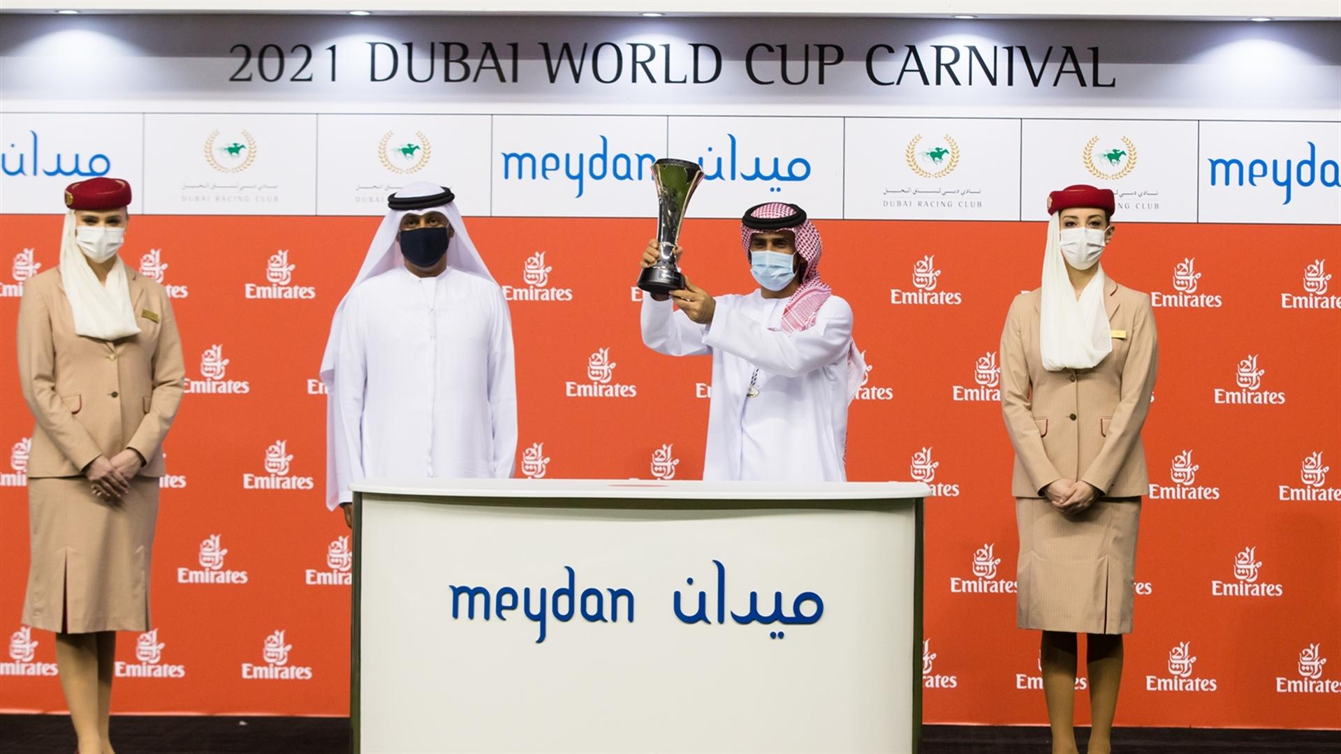 Salem Al Sabouse accepts the trophy for the Emirates Skywards 1000m race, from Khalid Al Haddad-VP Skywards Members & Operations on February 11, 2021. (Credit: Erika Rasmussen//DRC)
