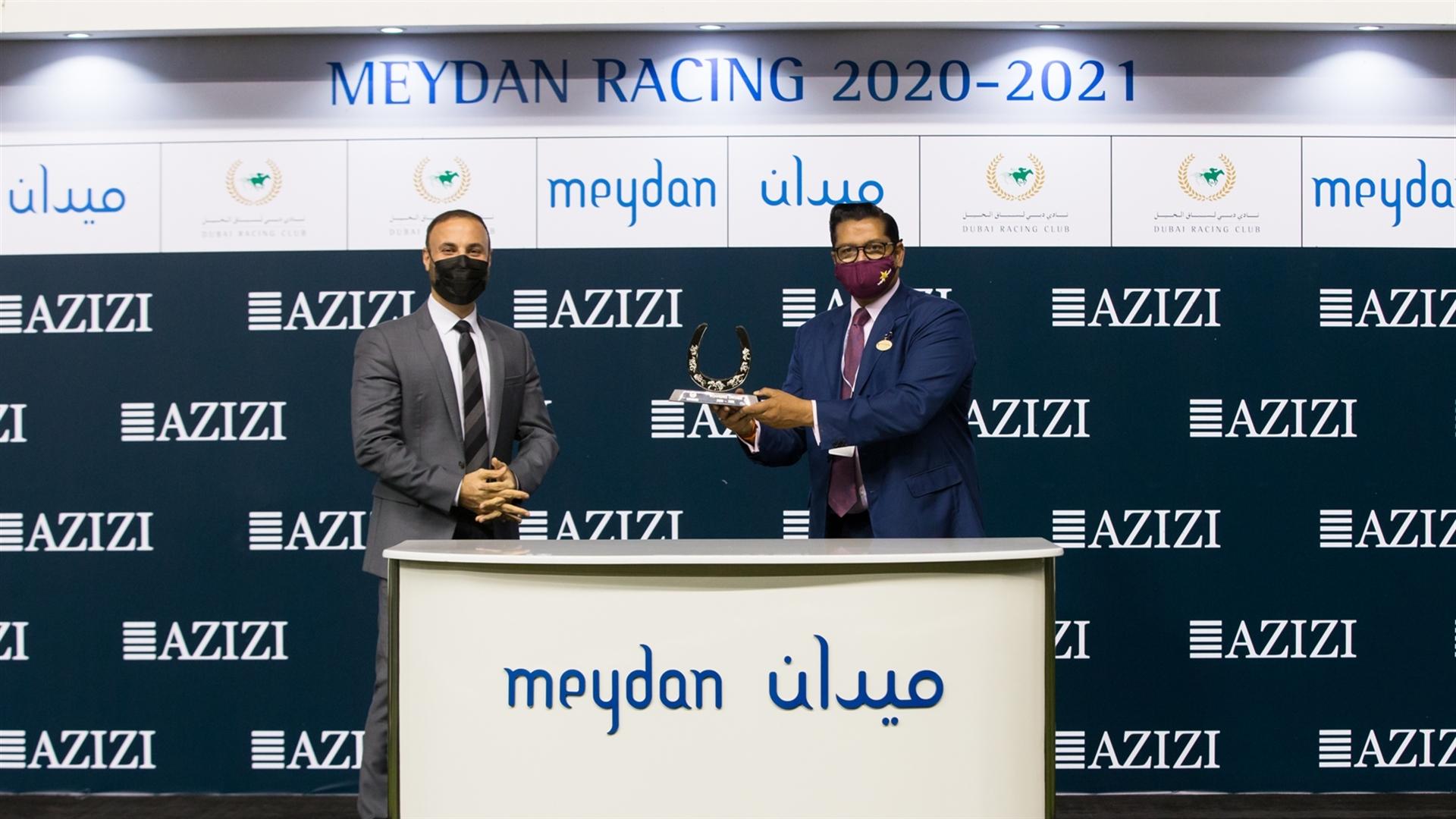 Winning trainer Satish Seemar accepts the trophy for the 2000m Dirt, Riviera By Azizi, from Farhad, CEO on March 11, 2021. (Credit: Dubai Racing Club // Erika Rasmussen)
