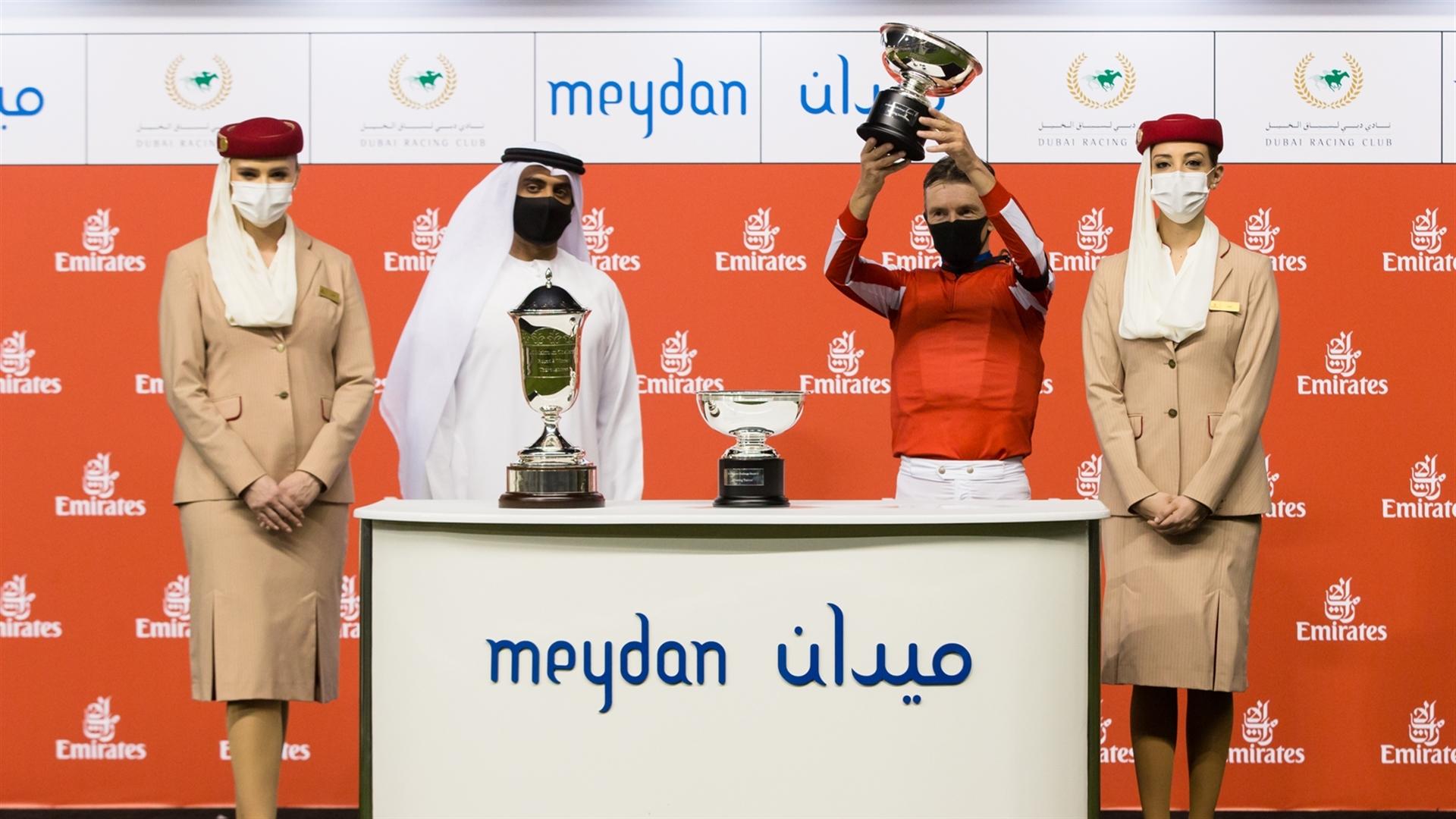 Adrie De Vries accepts the trophy for the Al Maktoum Challenge (Round 2) Sponsored By Emirates Airline race on February 11, 2021. (Credit: Erika Rasmussen//DRC)