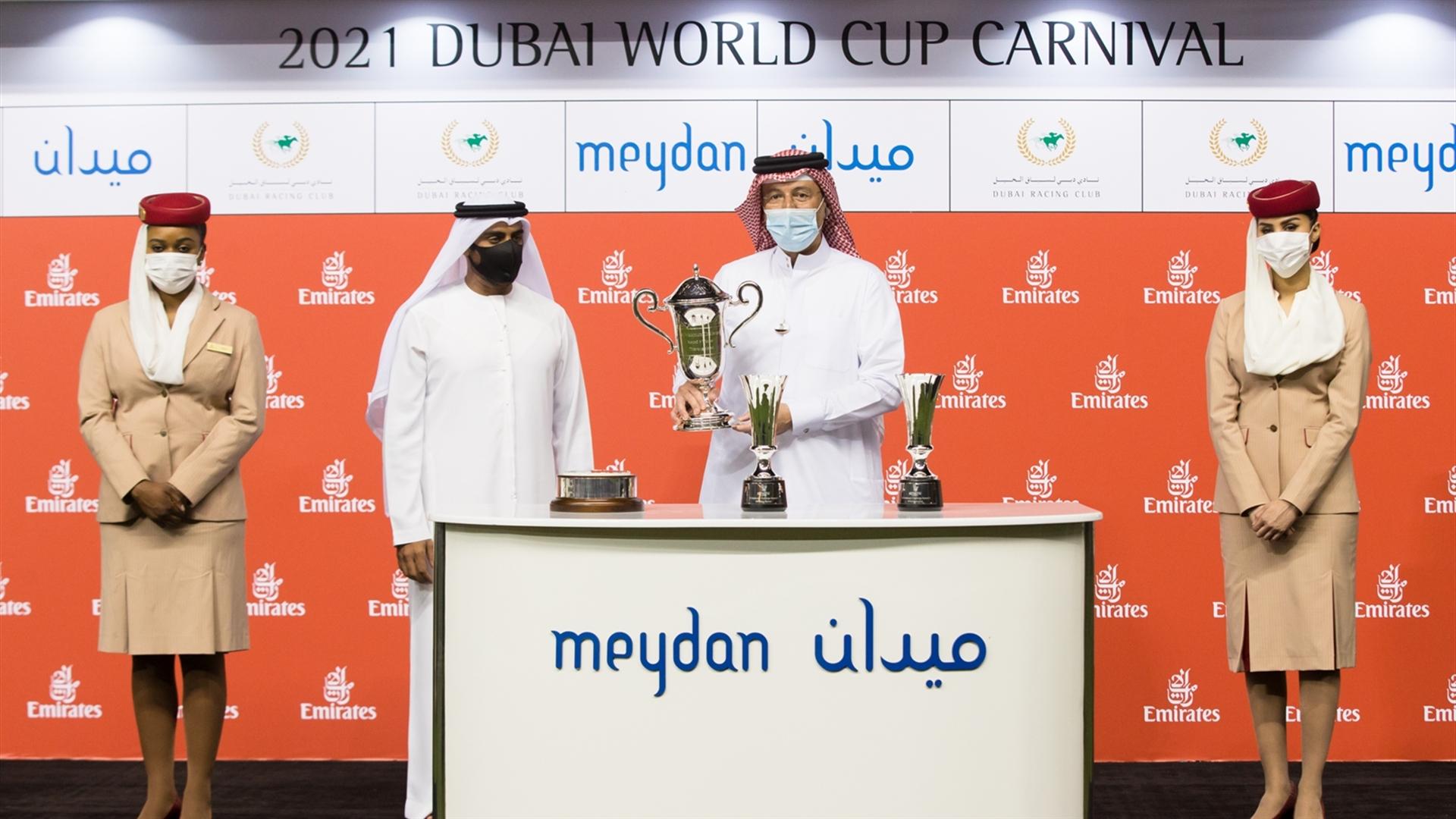 Fawzi Nass accepts the trophy for the Al Maktoum Challenge R3 Sponsored By Emirates Airline from Khalid Bel Jaflah, Div. VP Commercial Ops on March 06, 2021. (Credit: Erika Rasmussen//DRC)