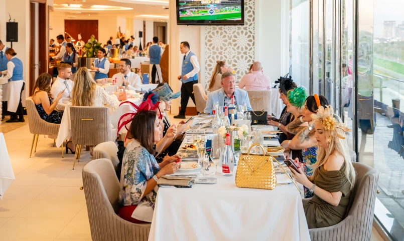 Guests dining with trackside views