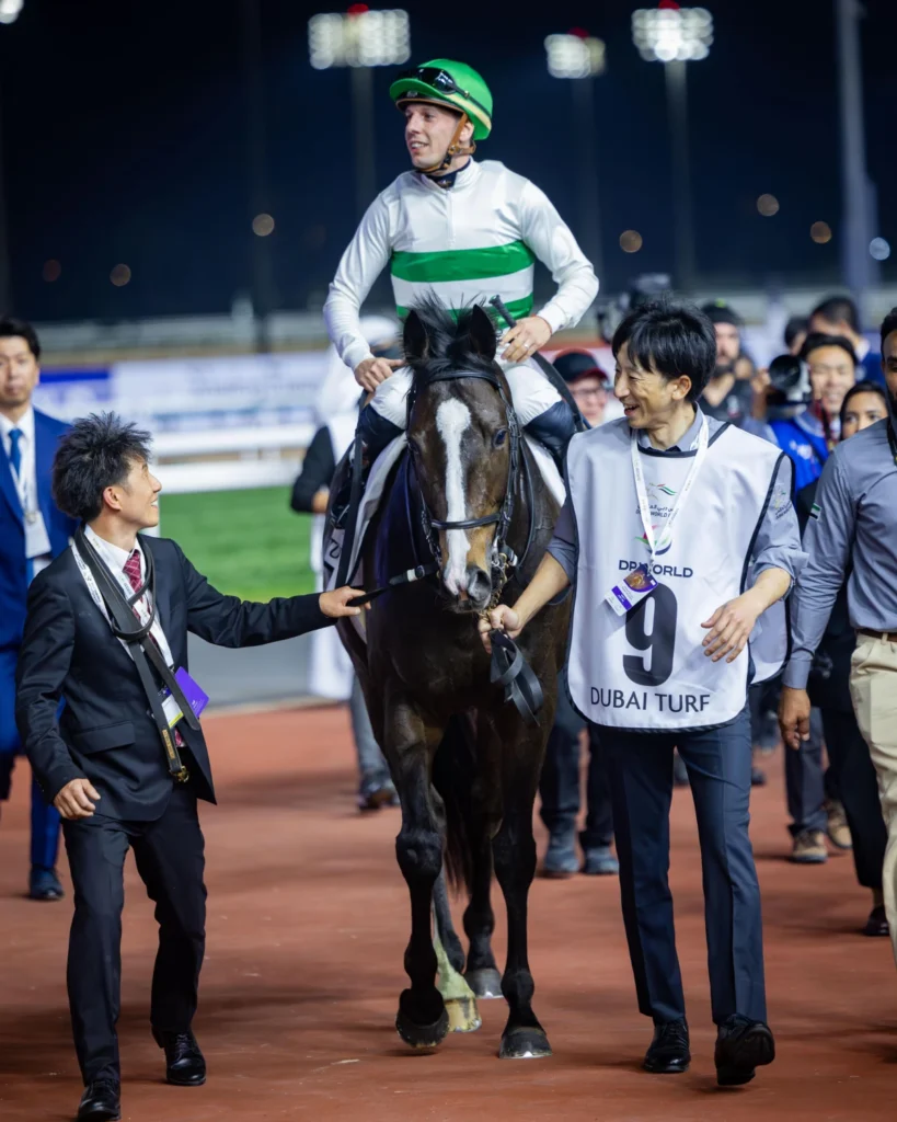 Winning jockey celebrates with horse