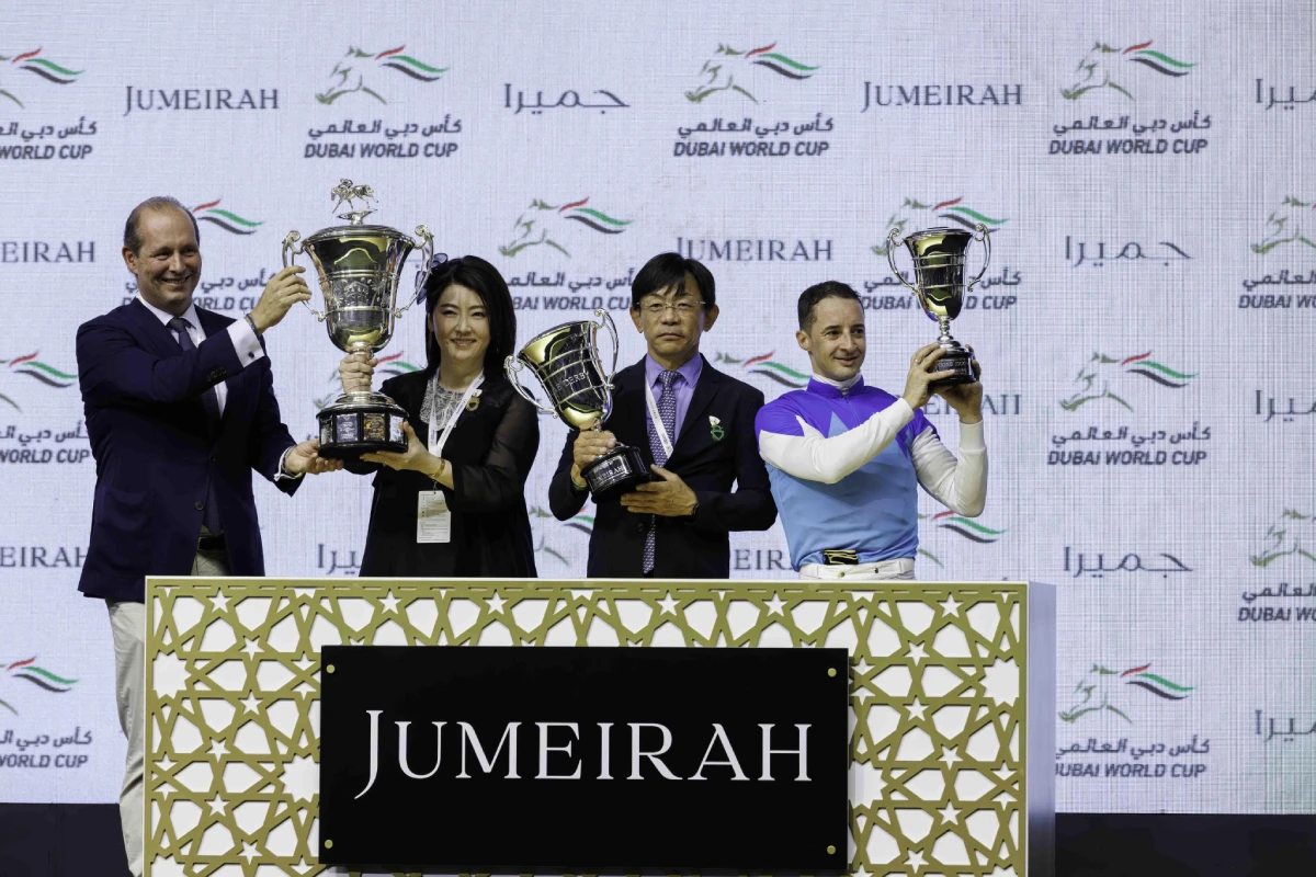 Racing officials displaying racing trophies
