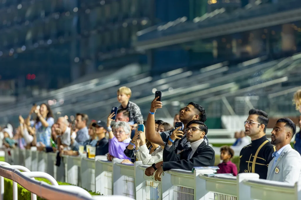 Crowd at an event taking photos.
