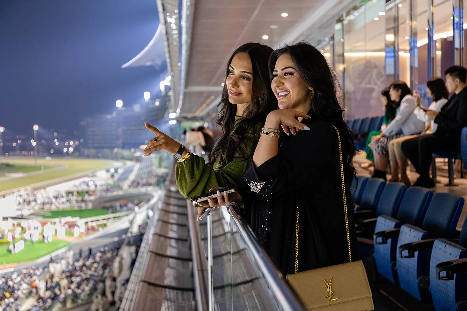 Friends enjoying Dubai Racing Club views