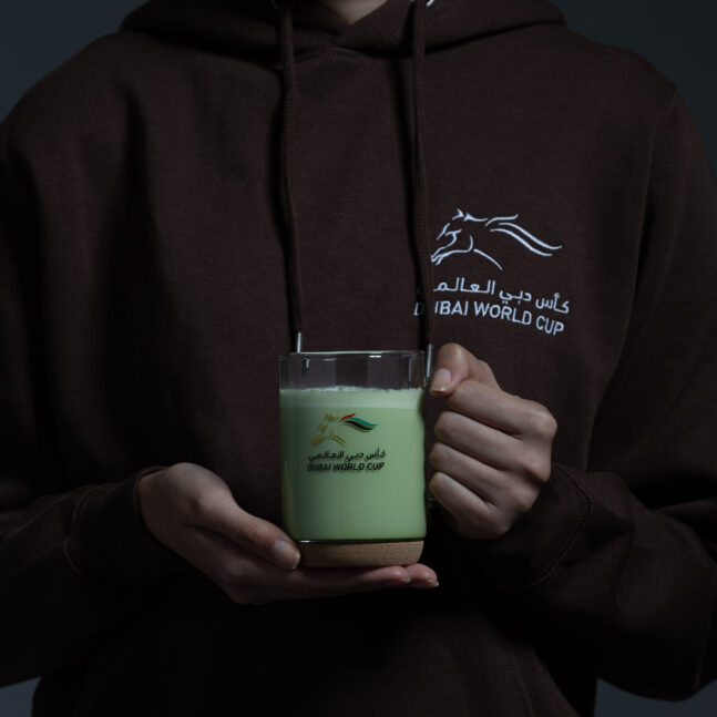 Person holding a clear glass mug